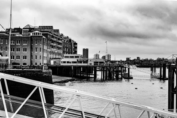 Pier and jetties on a tidal river, in black and white