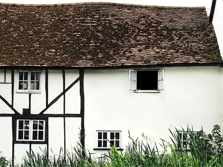 Timber-framed listed cottage with an old handmade clay tile roof, where re-roofing needs listed building consent