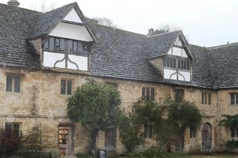 Stone building with a slate roof and timber-framed dormers