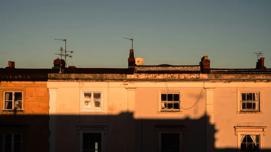 Rendered terrace with chimney stacks along the roofline at dusk