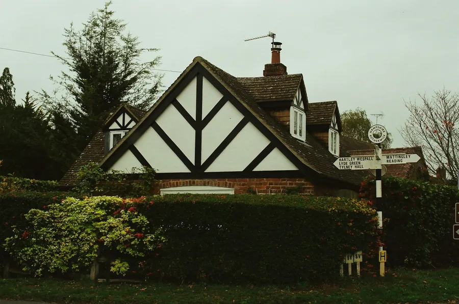 Mock-Tudor gable house behind a hedge