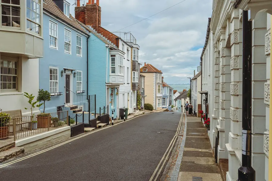 Painted terraced houses along a narrow street