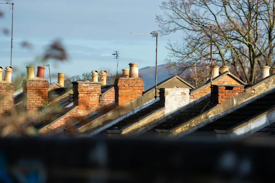 Row of chimney stacks along a terrace roofline