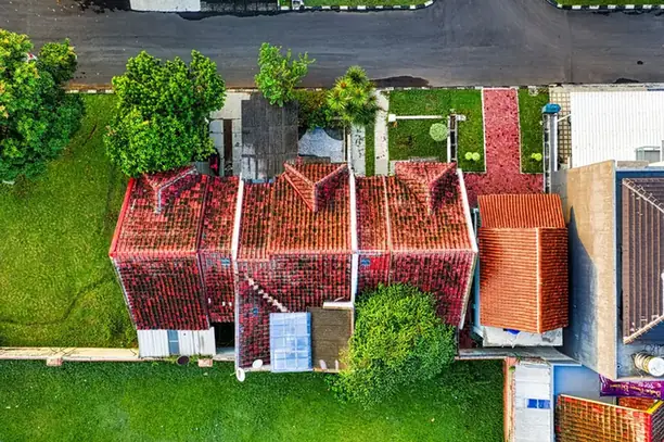 Aerial view of semi-detached houses with red tiled roofs and long gardens