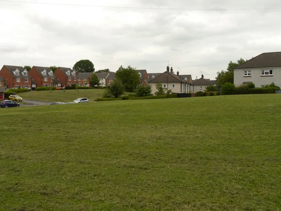 Houses with tiled roofs at the edge of a field