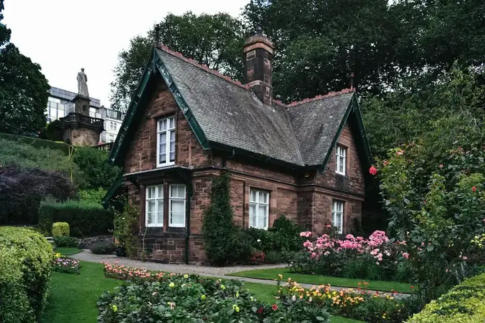 Victorian brick lodge with a slate roof and tall chimney