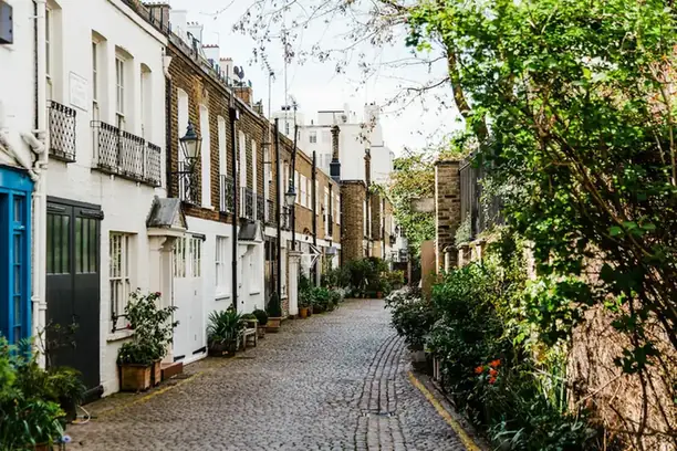 Cobbled mews lined with terraced cottages and climbing plants
