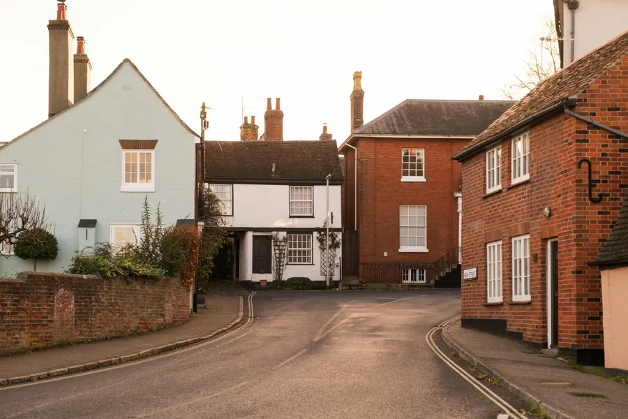 Village street lined with painted and red brick houses